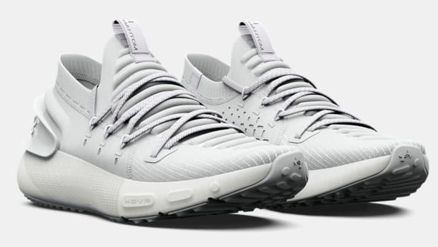 Side view of grey Under Armour running shoes.